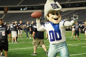 Dallas Cowboys mascot on the field at AT&T Stadium engaging guests—highlighting Arlington DMC fan experiences and entertainment options.