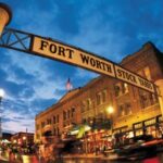 Fort Worth Stockyards sign illuminated at dusk—an iconic venue enhanced by the best DMC in Fort Worth for immersive cultural experiences.