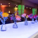 Colorful floral arrangements on a glowing event table—expertly styled by the best DMC in Fort Worth for a vibrant, modern gathering.