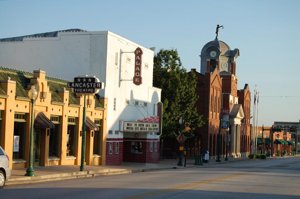 Charming view of Historic Downtown Grapevine with classic storefronts and the Lancaster Theatre—highlighting venues supported by a Grapevine DMC.