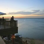 People enjoying a sunset view from a lakeside deck at Lake Grapevine—ideal for outdoor events coordinated by a Grapevine DMC.
