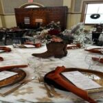 Western-inspired table setting featuring a cowboy boot floral centerpiece and rustic elements—uniquely styled by Texas corporate event planners.